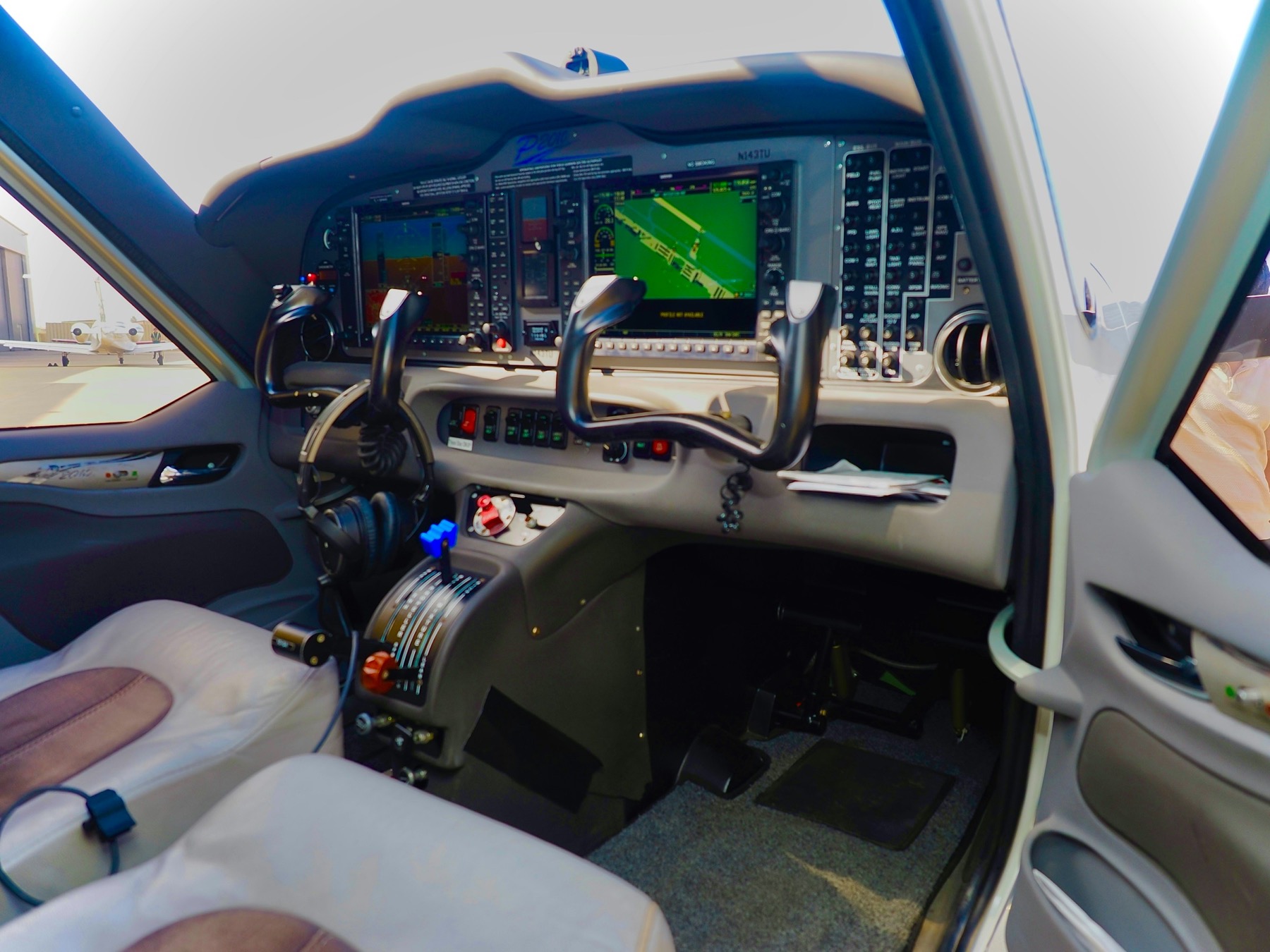 Glass cockpit primary flight and navigation displays in a general aviation panel at dusk, suggesting IFR procedure practice